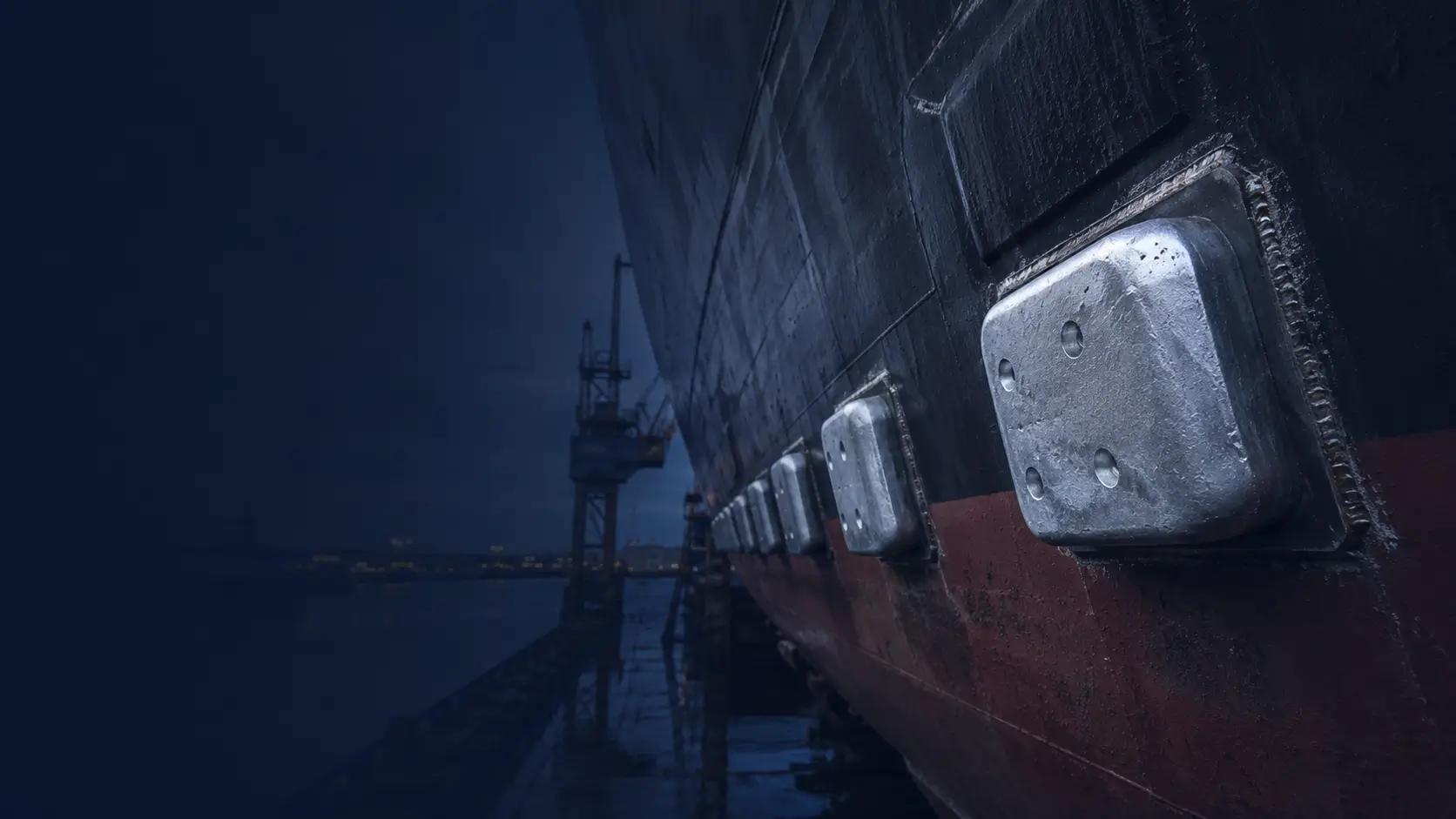 Ship hull with installed sacrificial anodes